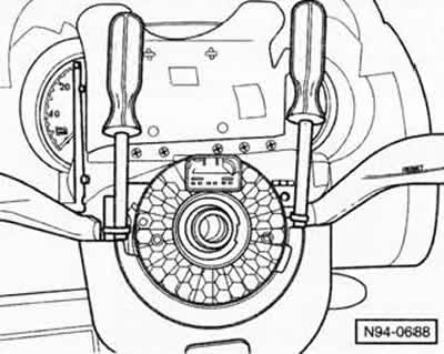 Move the steering wheel adjustment lever forward and unscrew the screw at the bottom of the trim.