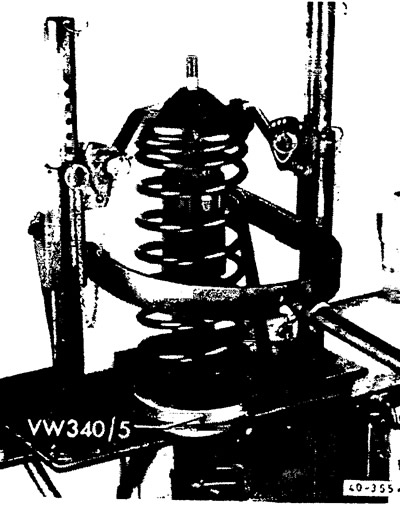 Compress the coil spring using a spring compressor until the threads on the piston rod protrude…