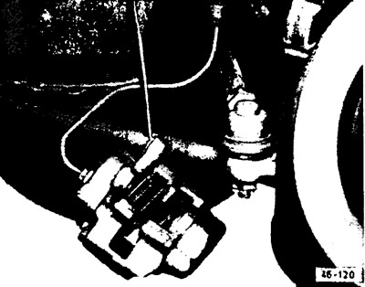 Remove the brake caliper from the steering knuckle and hang it on a wire.