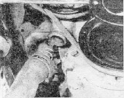 Photo 8.6. Disconnecting the water pump hoses.