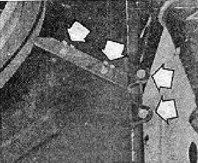 Photo 5.16. Air deflector mounting bolts (shown by arrows).
