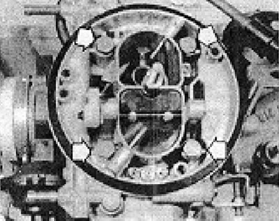 Photo 6B.14. Carburetor mounting bolts to manifold (shown by arrows).